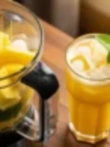 Copo de suco de abacaxi com hortelã e gelo em fundo claro